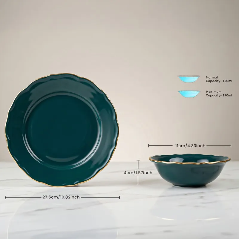 Close view of a dark teal plate and matching bowl with gold rim