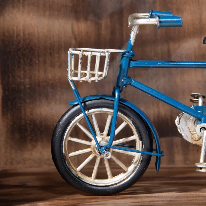 Close-up of front wheel and basket on dark blue bicycle showpiece