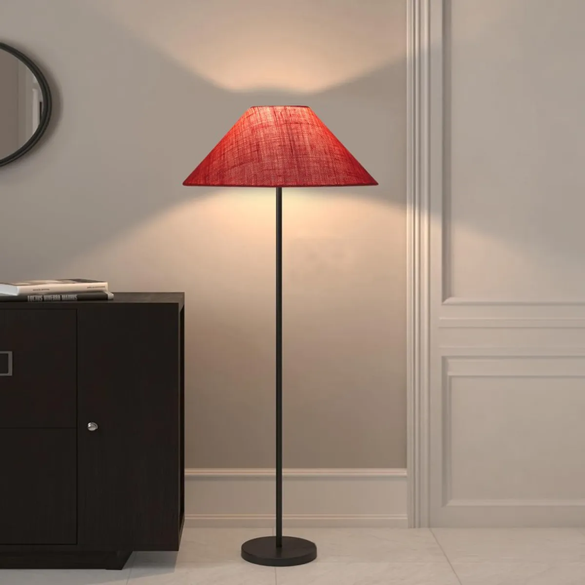 Pink floor lamp with black stand against a beige wall beside a cabinet