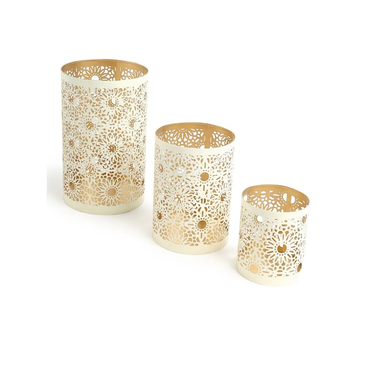 Three white floral lattice candle holders arranged diagonally on a white background