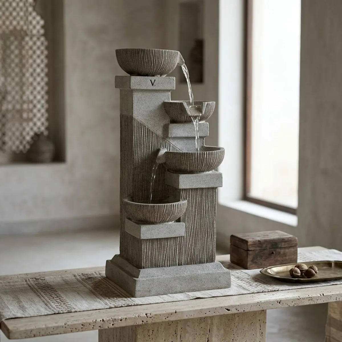 Textured bowl cascade fountain styled on a console table