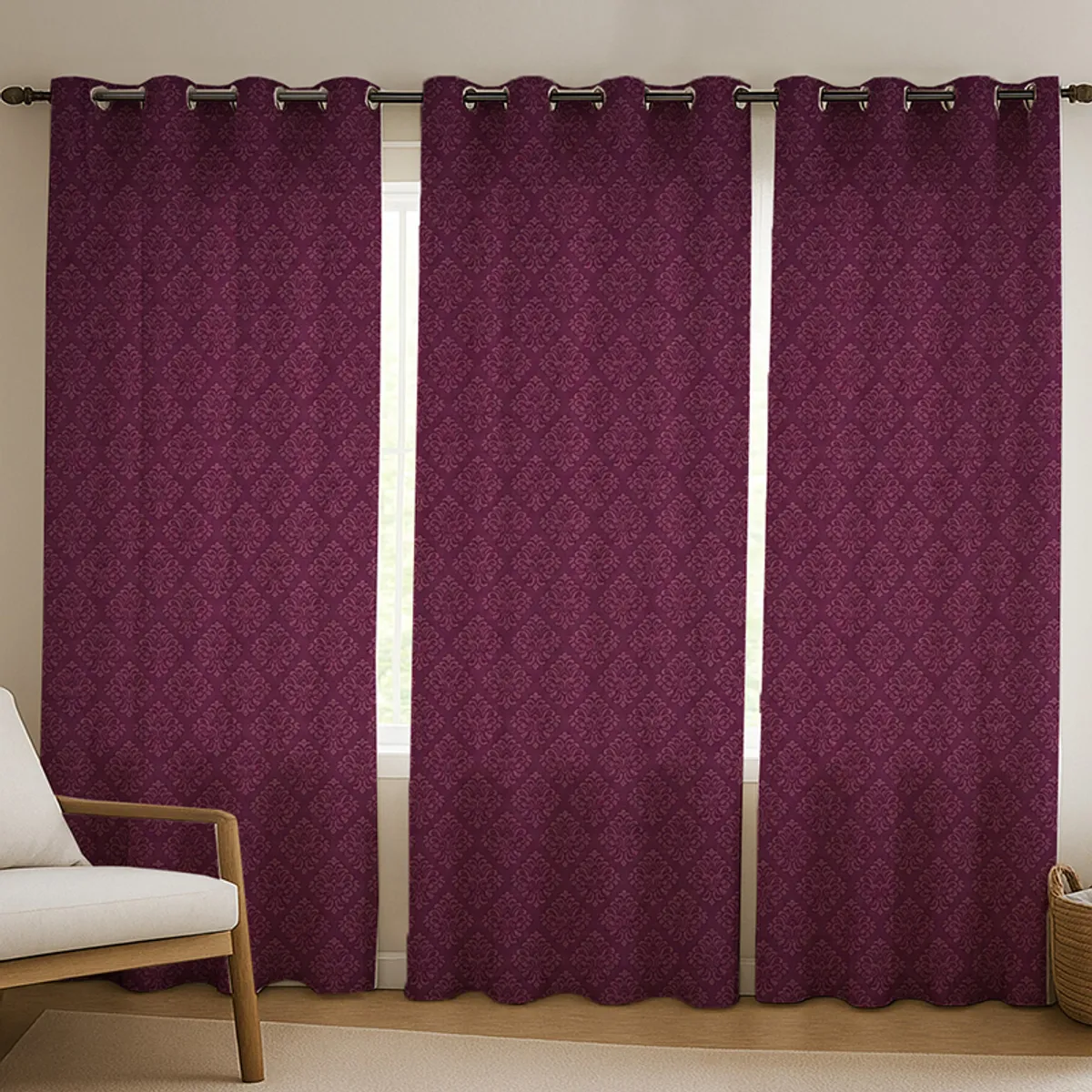 Three maroon patterned curtains hanging across a window