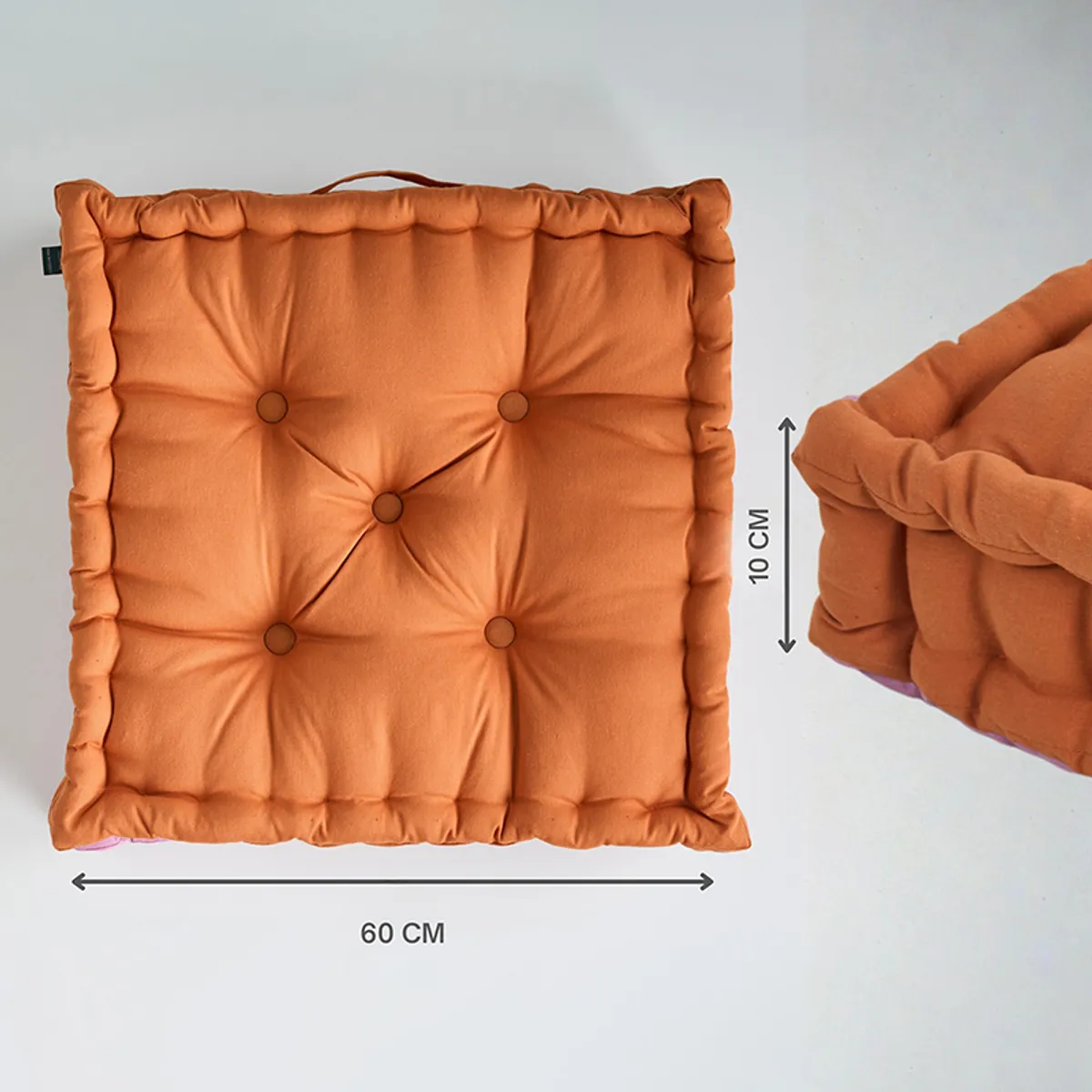 Brown tufted floor cushion shown from above with side profile and handle