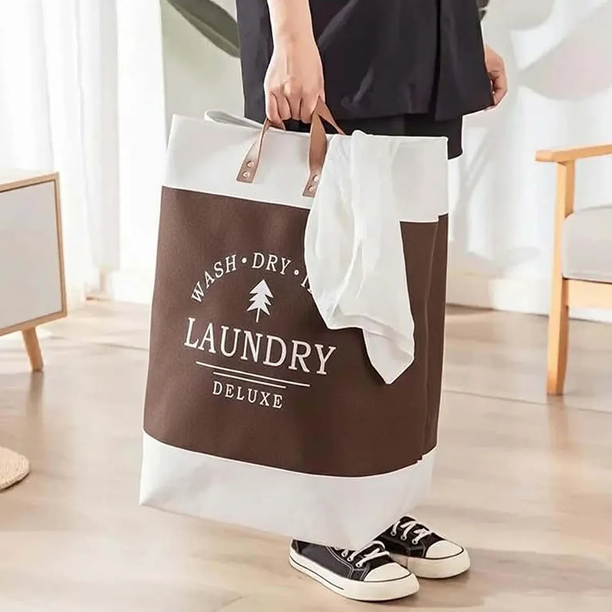 Person carrying the brown and white storage basket by its handles