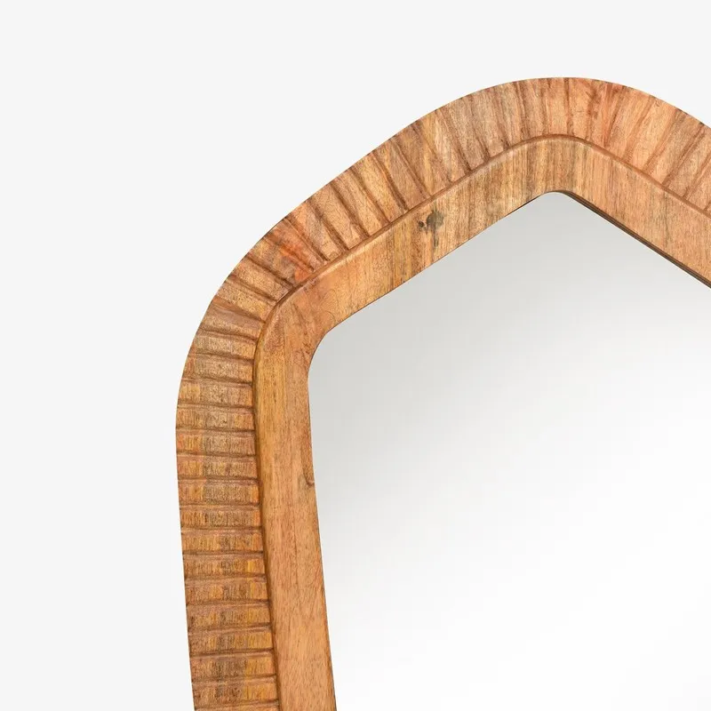 Close-up of the upper carved frame on the brown wood mirror