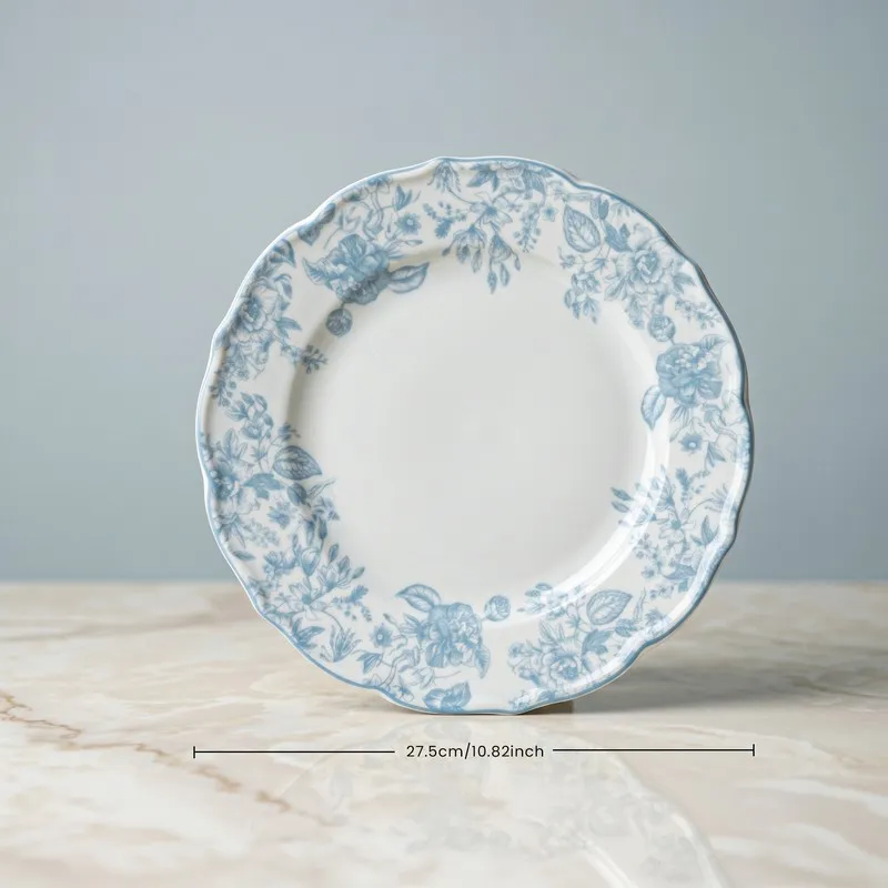 Single blue and white floral dinner plate on a tabletop