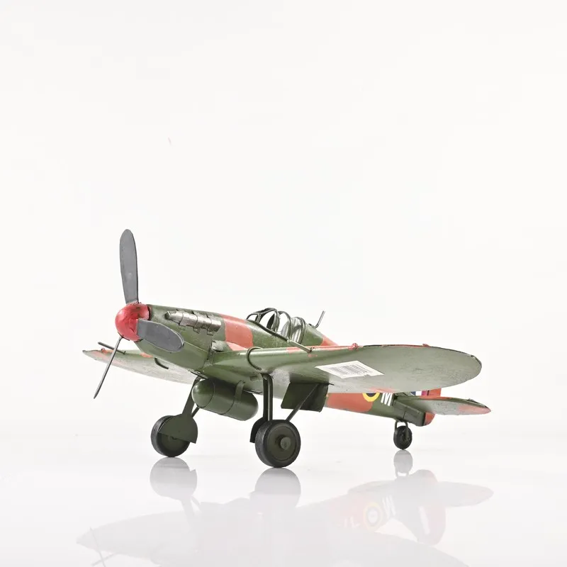 Side view of the red and green aeroplane tabletop showpiece on a white background
