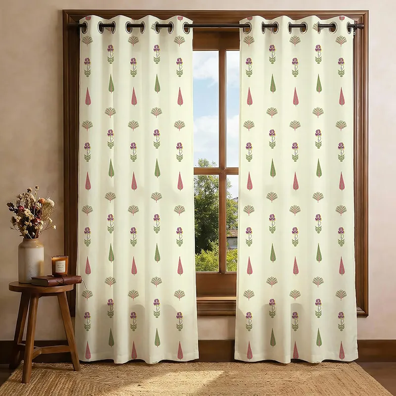 Pair of off-white printed curtains hanging on a wooden window
