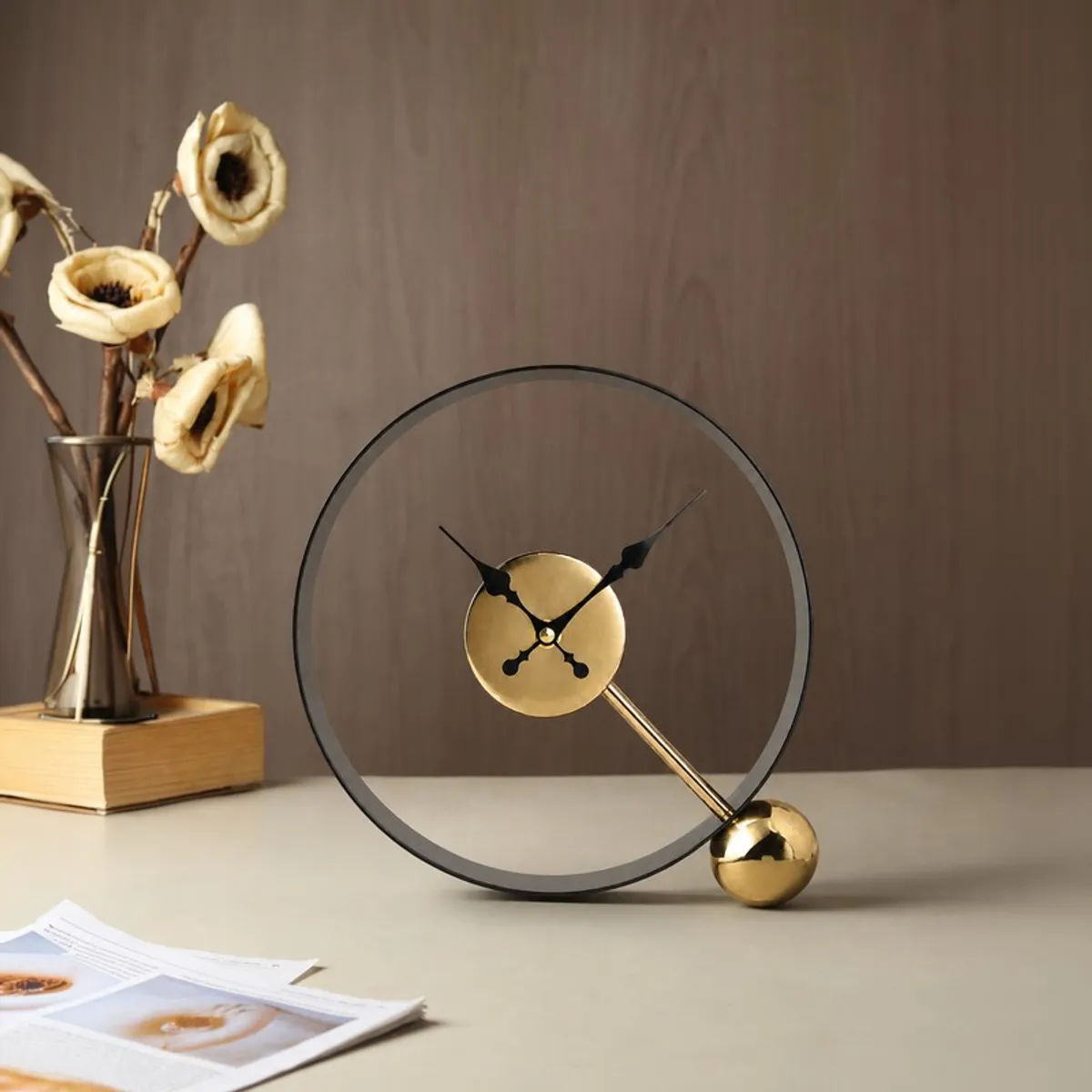 Contemporary black and gold round table clock on a tabletop