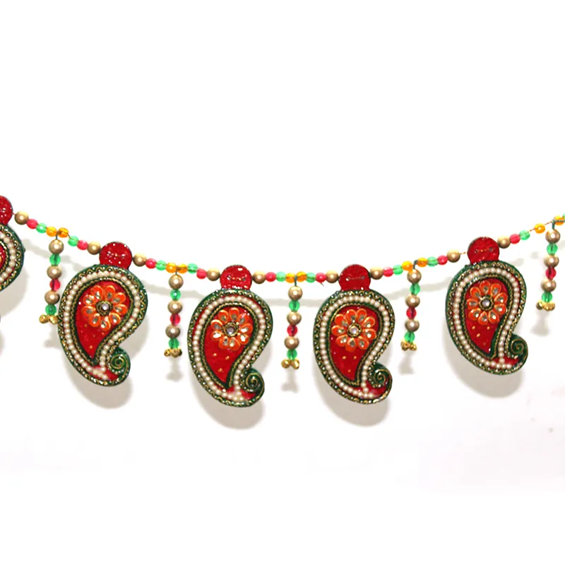 Close-up of red toran with beadwork and hanging decorative accents