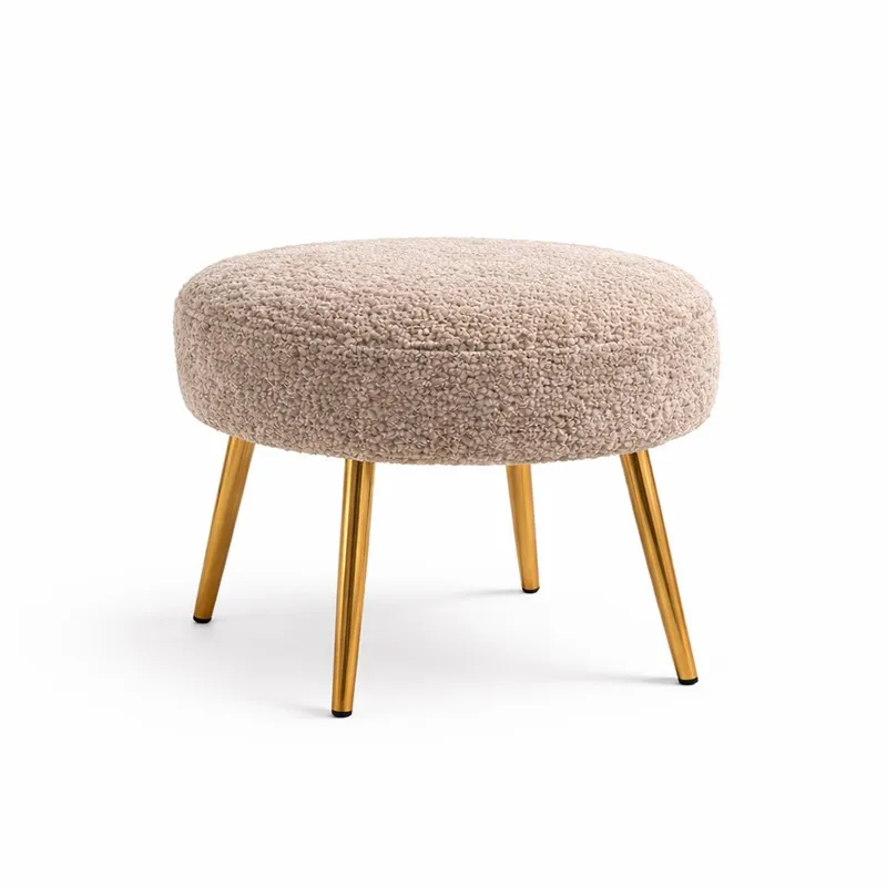 Round beige boucle stool with four gold-finished legs on white background