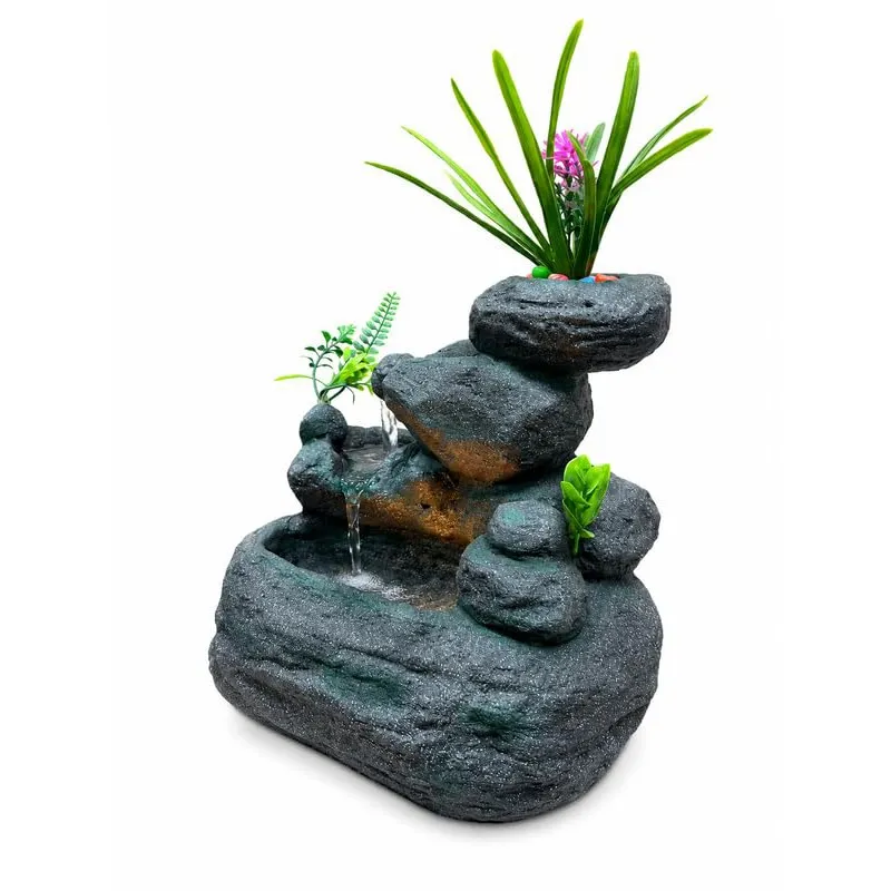 Grey rock-style LED tabletop fountain with faux plants on a white background