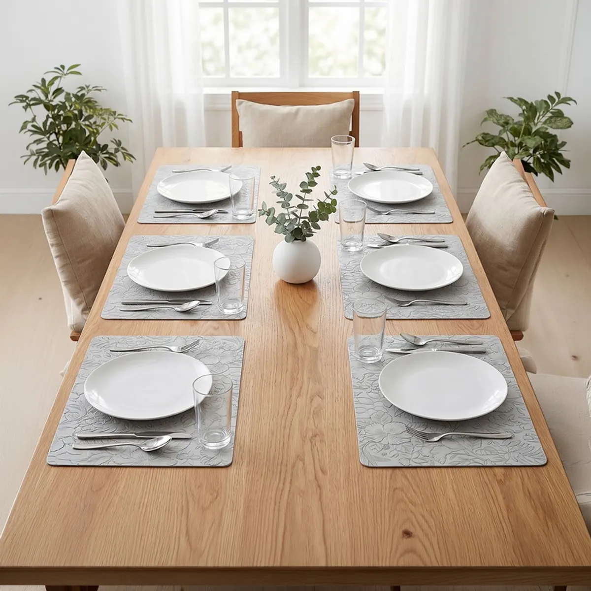 Six grey table mats arranged on a dining table setting