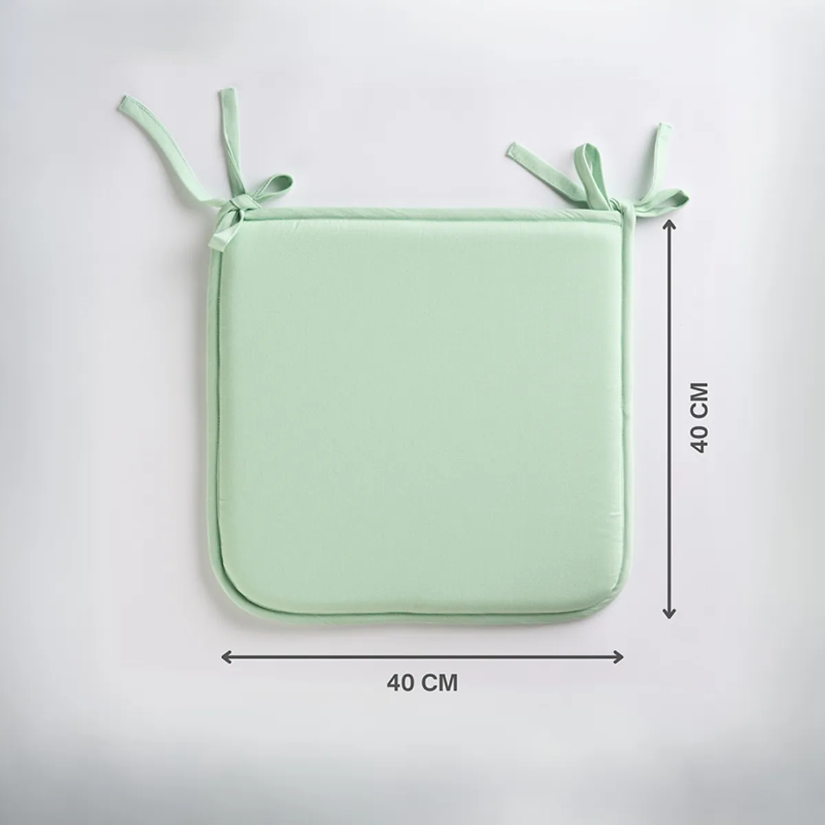 Single sage green square chair pad with tie-up corners shown flat