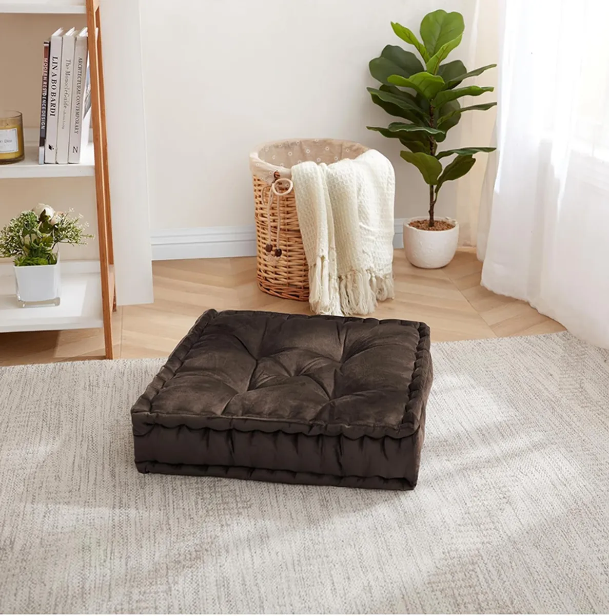 Brown square floor cushion placed on a light rug in a living room