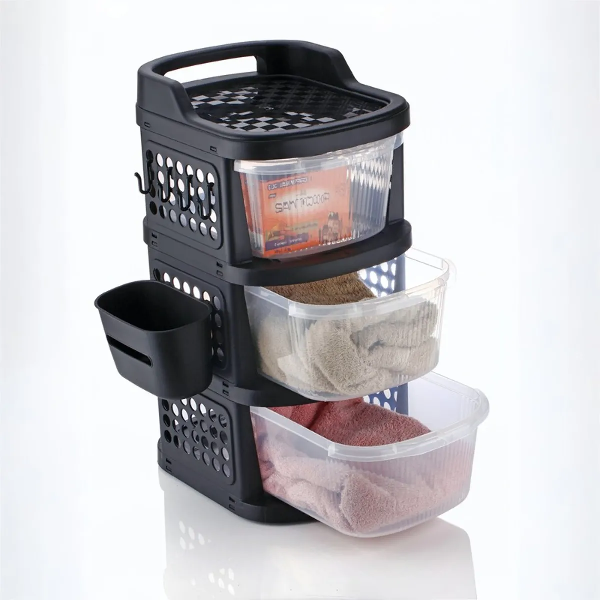 Close view of a black three-tier rack with transparent pull-out drawers and side basket