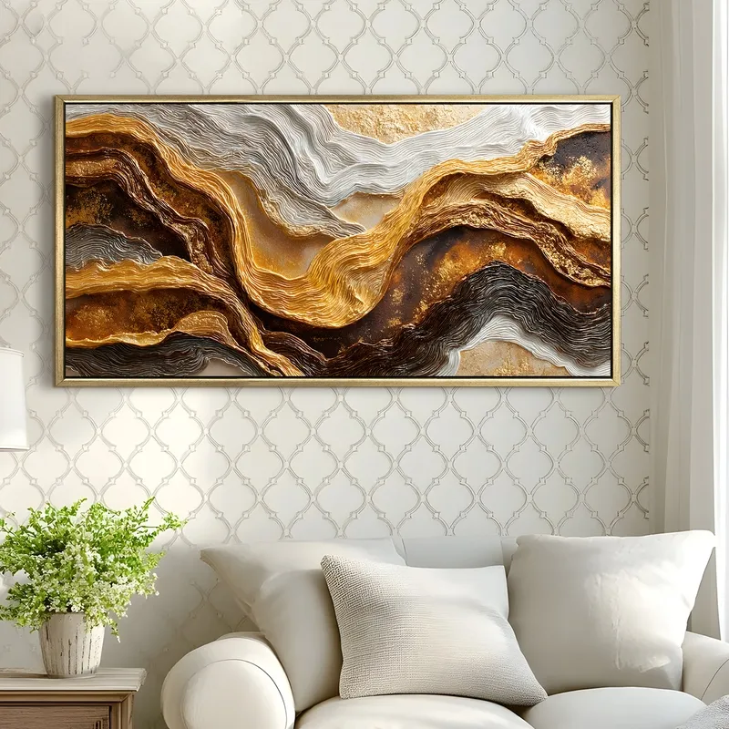 Gold, brown and white abstract framed wall art displayed above a white sofa