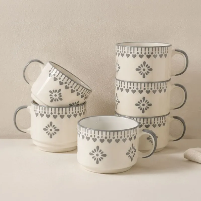 Stacked white ceramic tea cups with blue decorative motifs