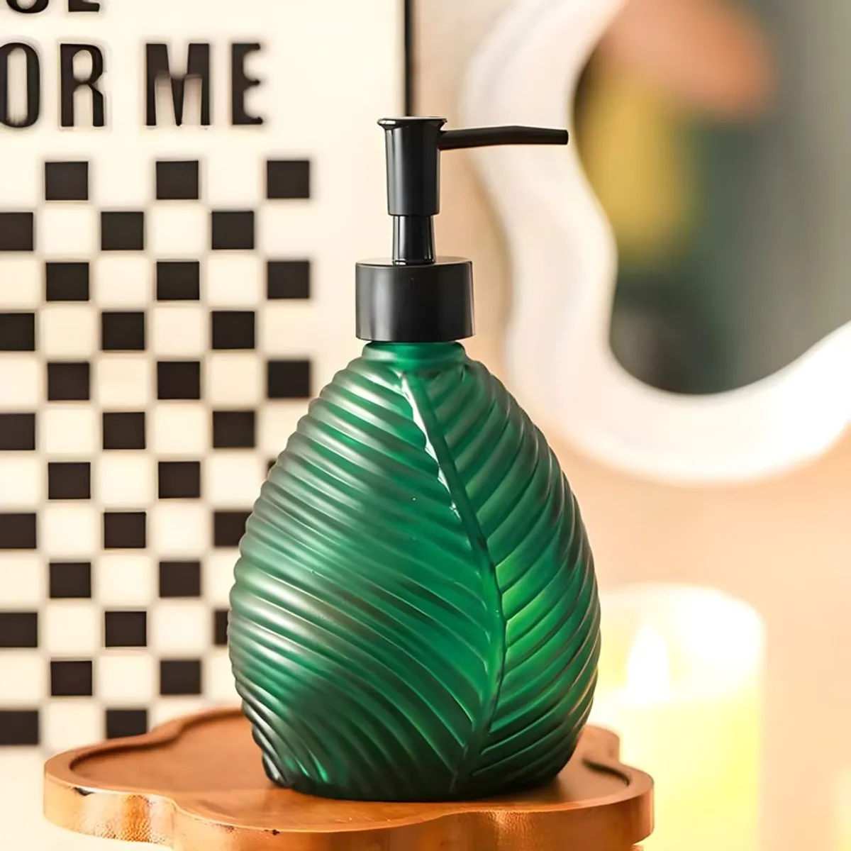 Green leaf-design soap dispenser displayed on a wooden tray