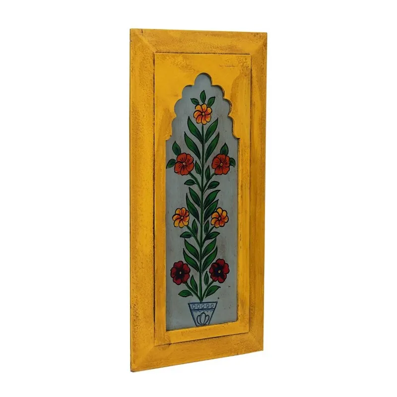 Angled view of a yellow rectangular wall accent with painted floral design