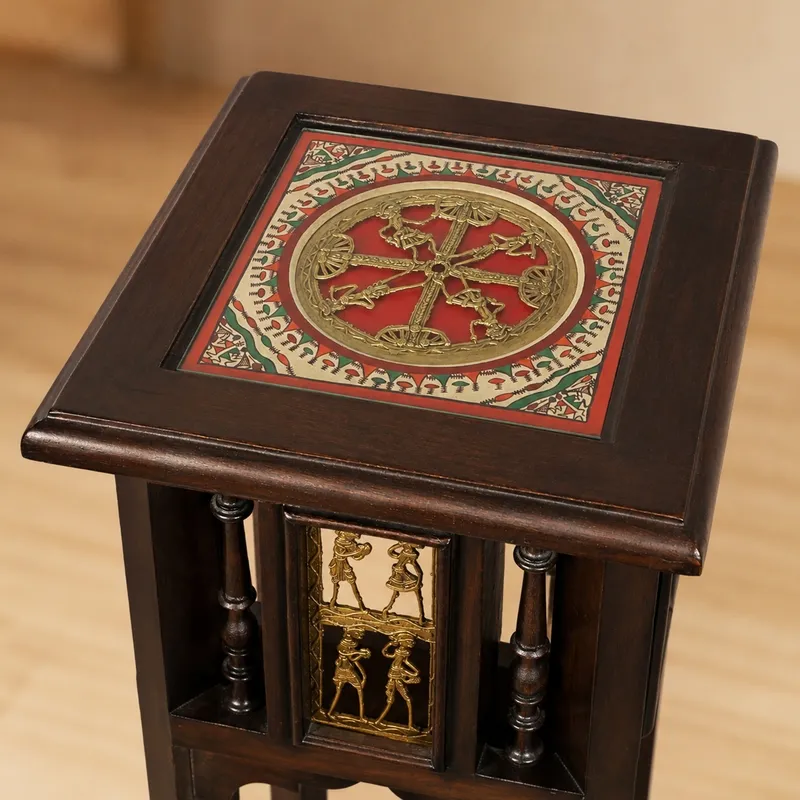 Close-up of the square tabletop with red and gold decorative artwork inset.