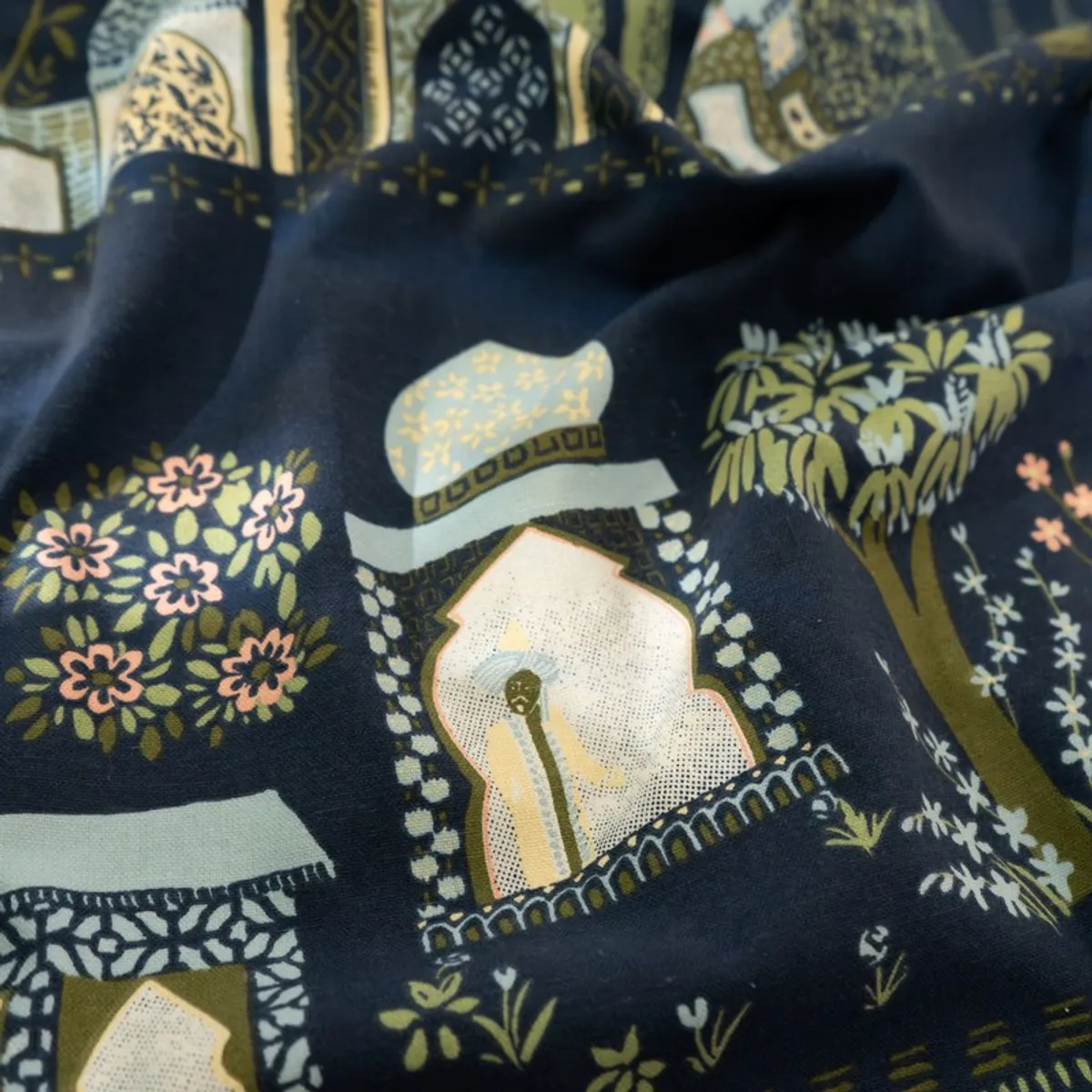 Close-up of the curtain's blue cotton fabric and detailed printed motifs.