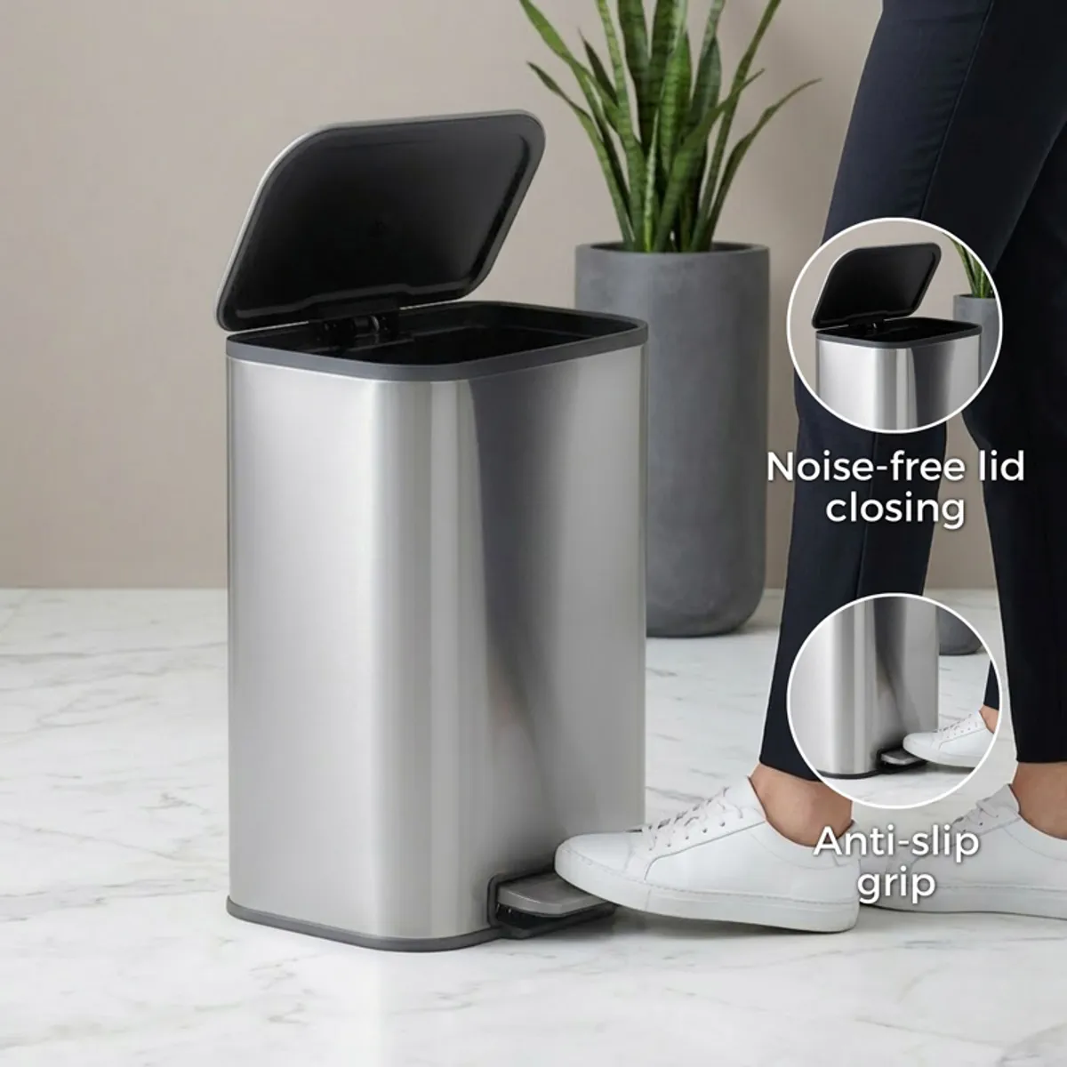 Silver dustbin shown open with a foot pedal in a contemporary interior