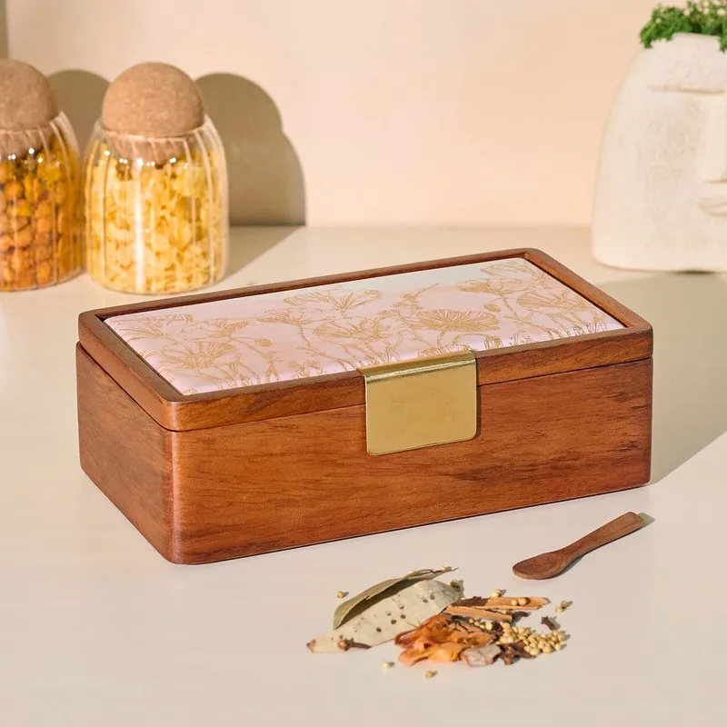 Closed brown wooden masala box with a pale floral lid and gold latch