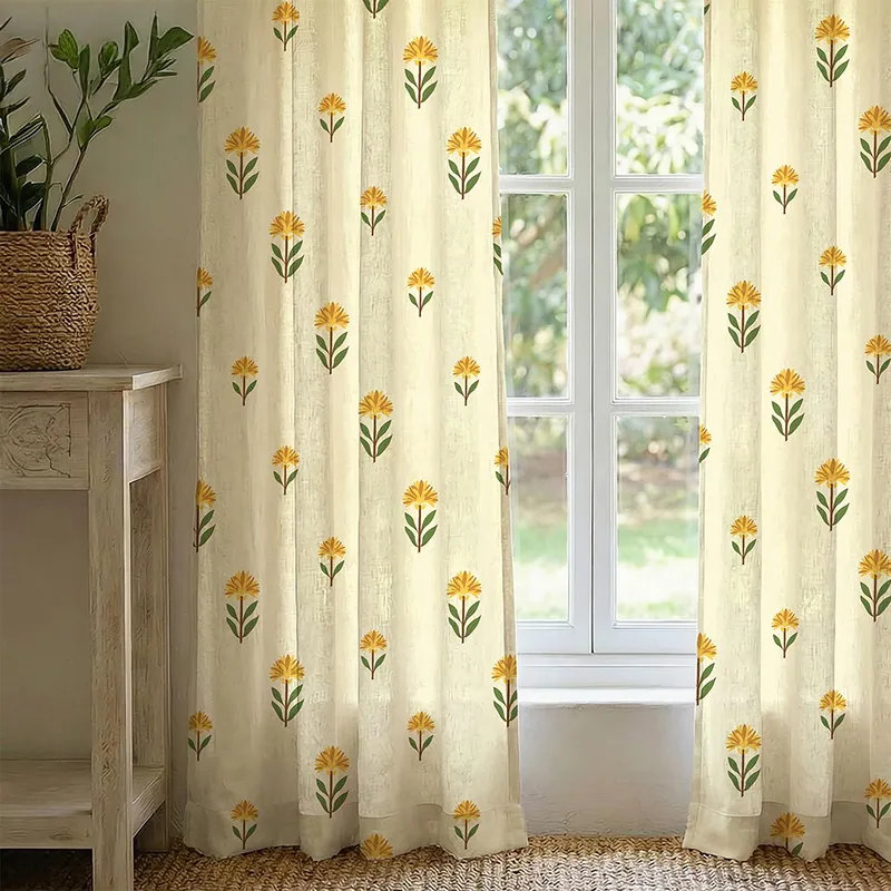 Pair of ivory curtains with yellow floral print framing a bright window