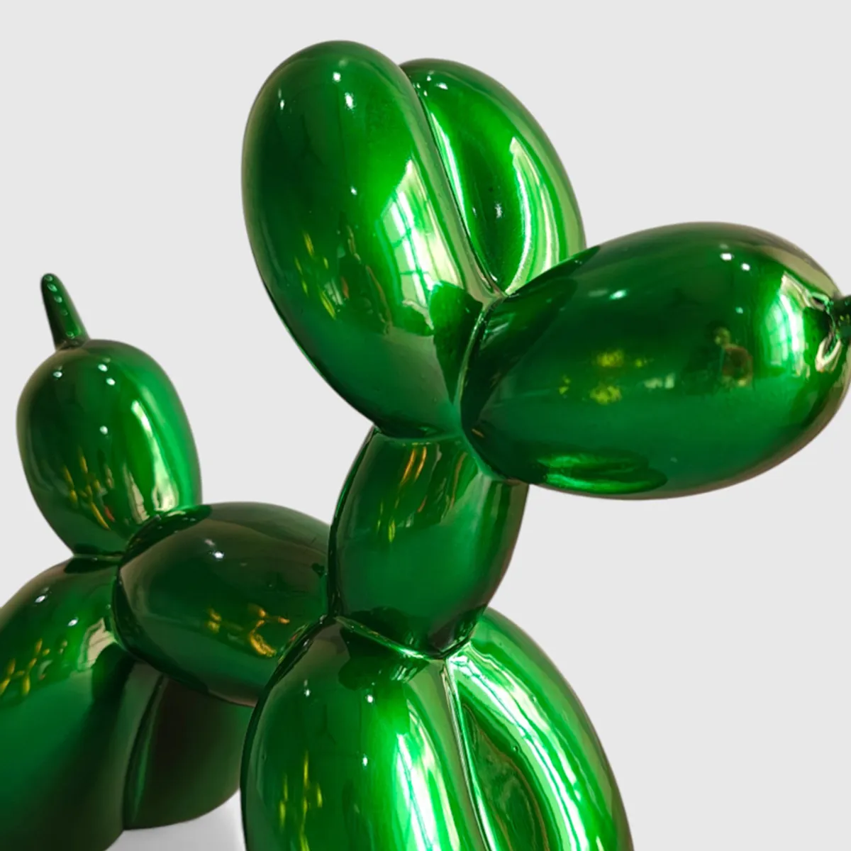 Close-up view highlighting the glossy green balloon-like dog form.