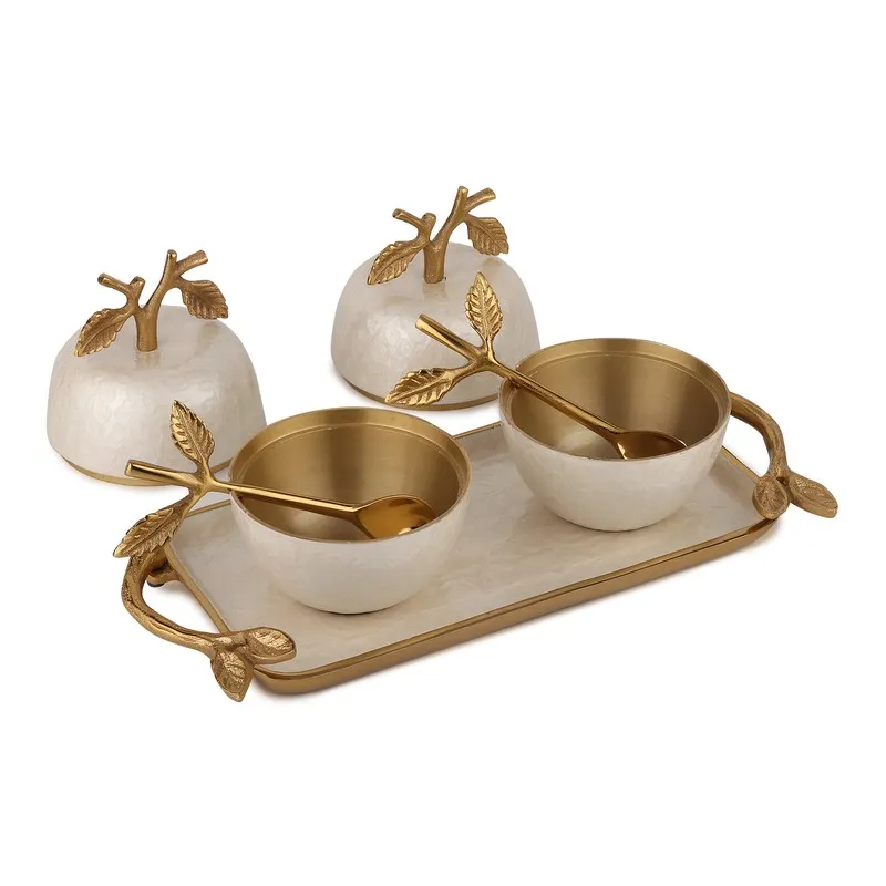 Open ivory jars with gold interiors and matching tray