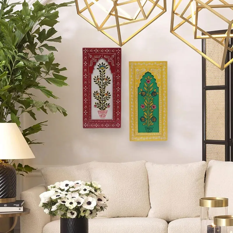Two bright wall accents displayed above a sofa in a living room