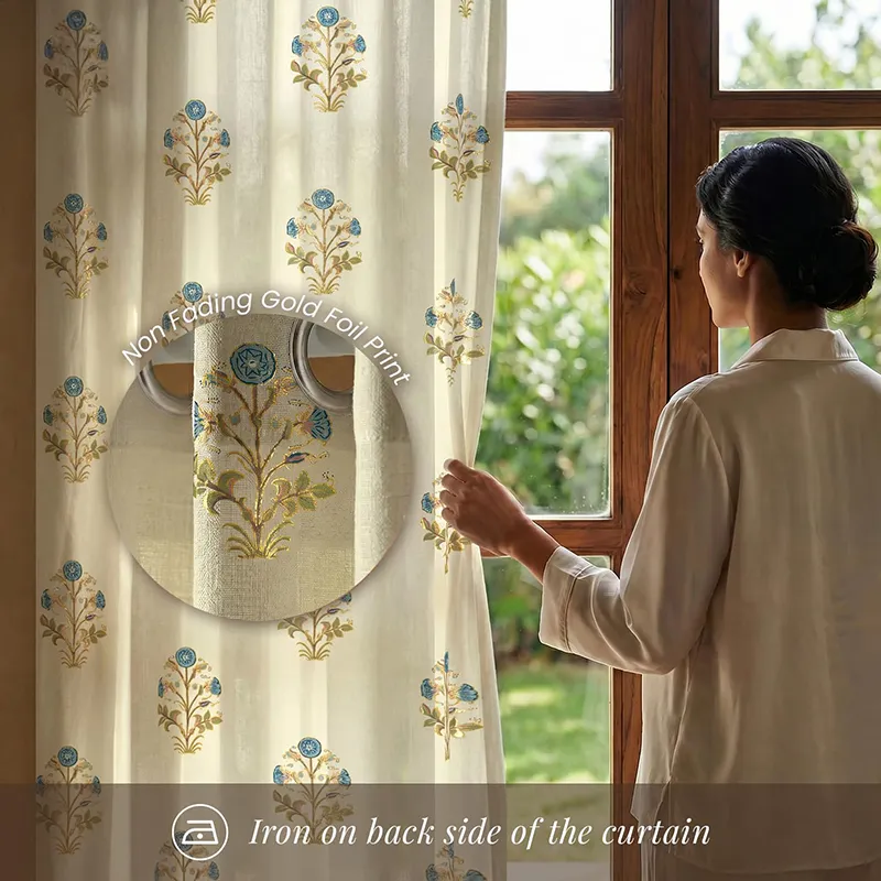 Floral foil printed curtain beside a window with blue and gold motif detail