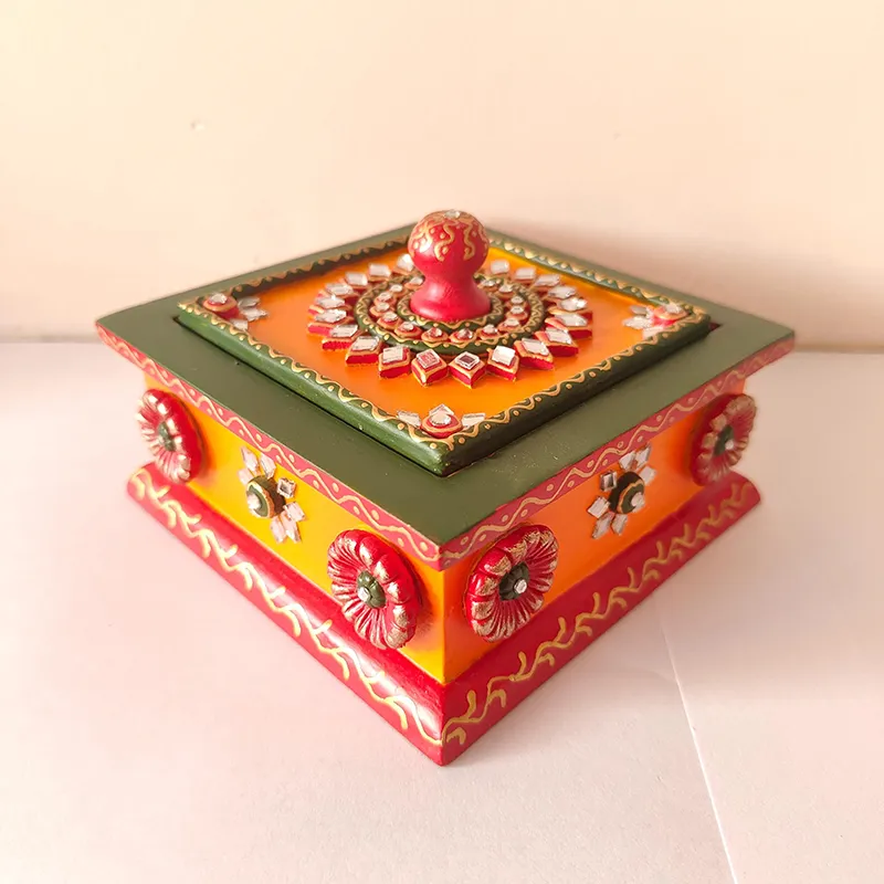 Angled view of ornate orange, green and red square storage box