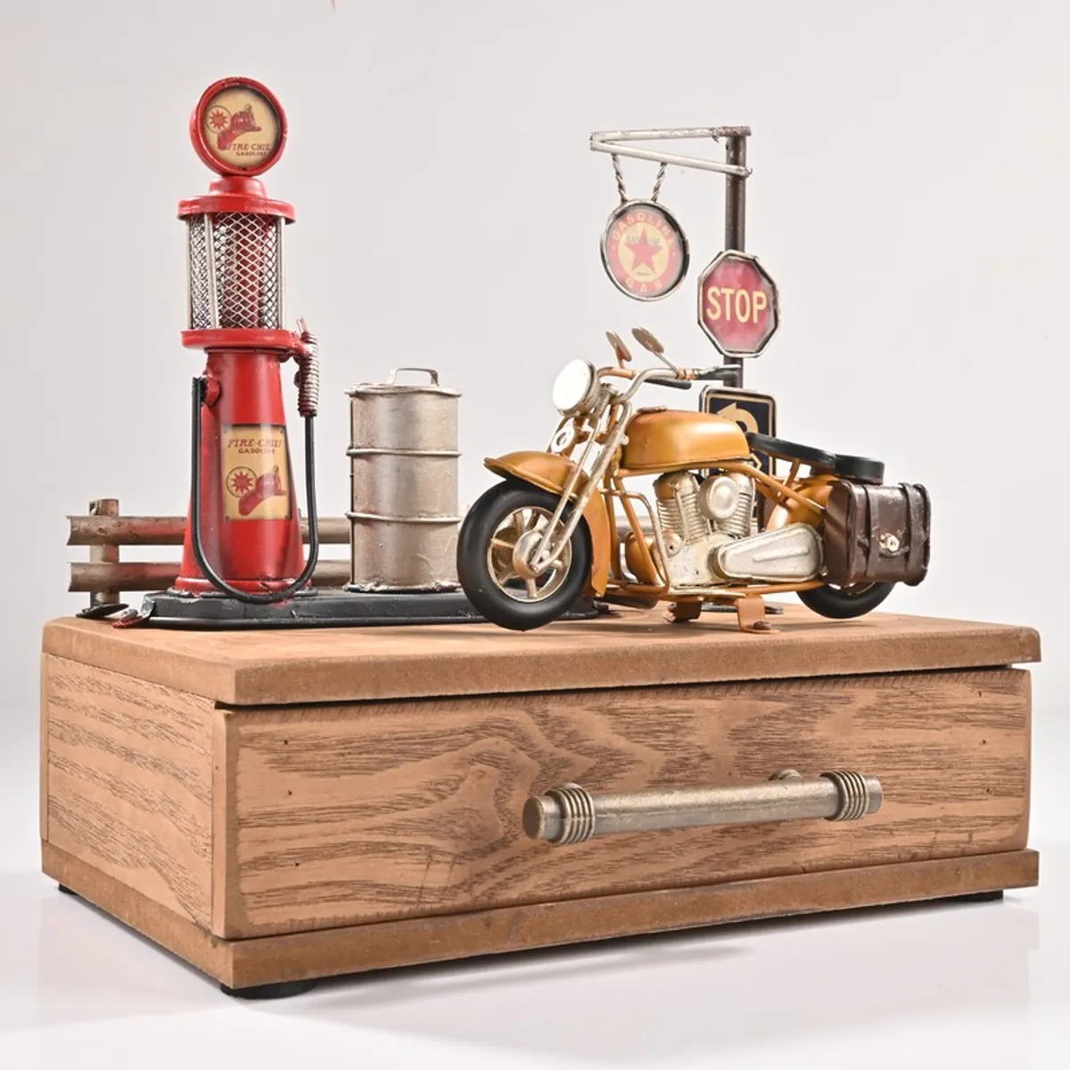 Heritage wooden storage box with motorcycle and petrol pump décor on a white background