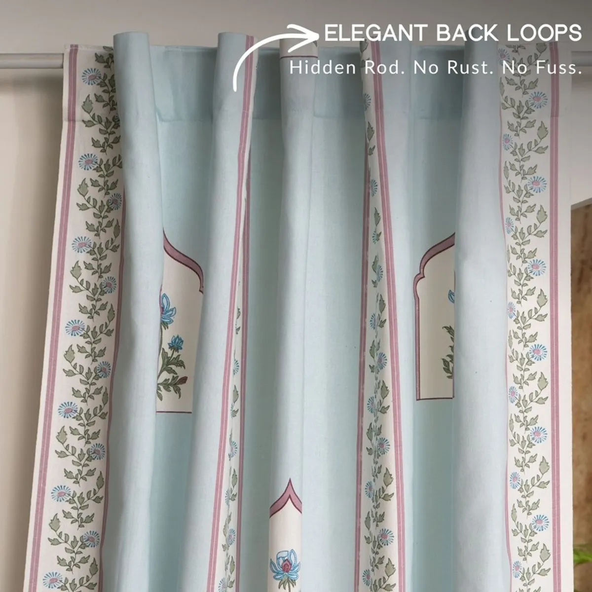 Light blue floral curtain panels shown hanging from a concealed rod.