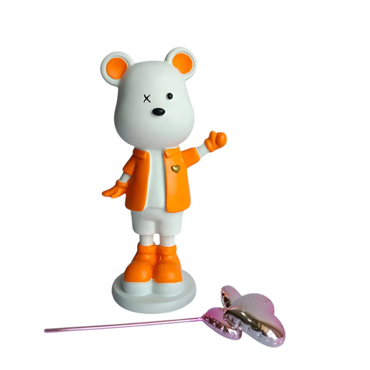 Bear showpiece beside its detached metallic heart-shaped balloon