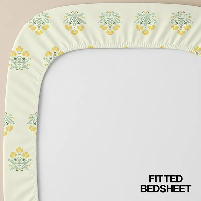 Corner view of off-white floral fitted bedsheet with elasticated edge