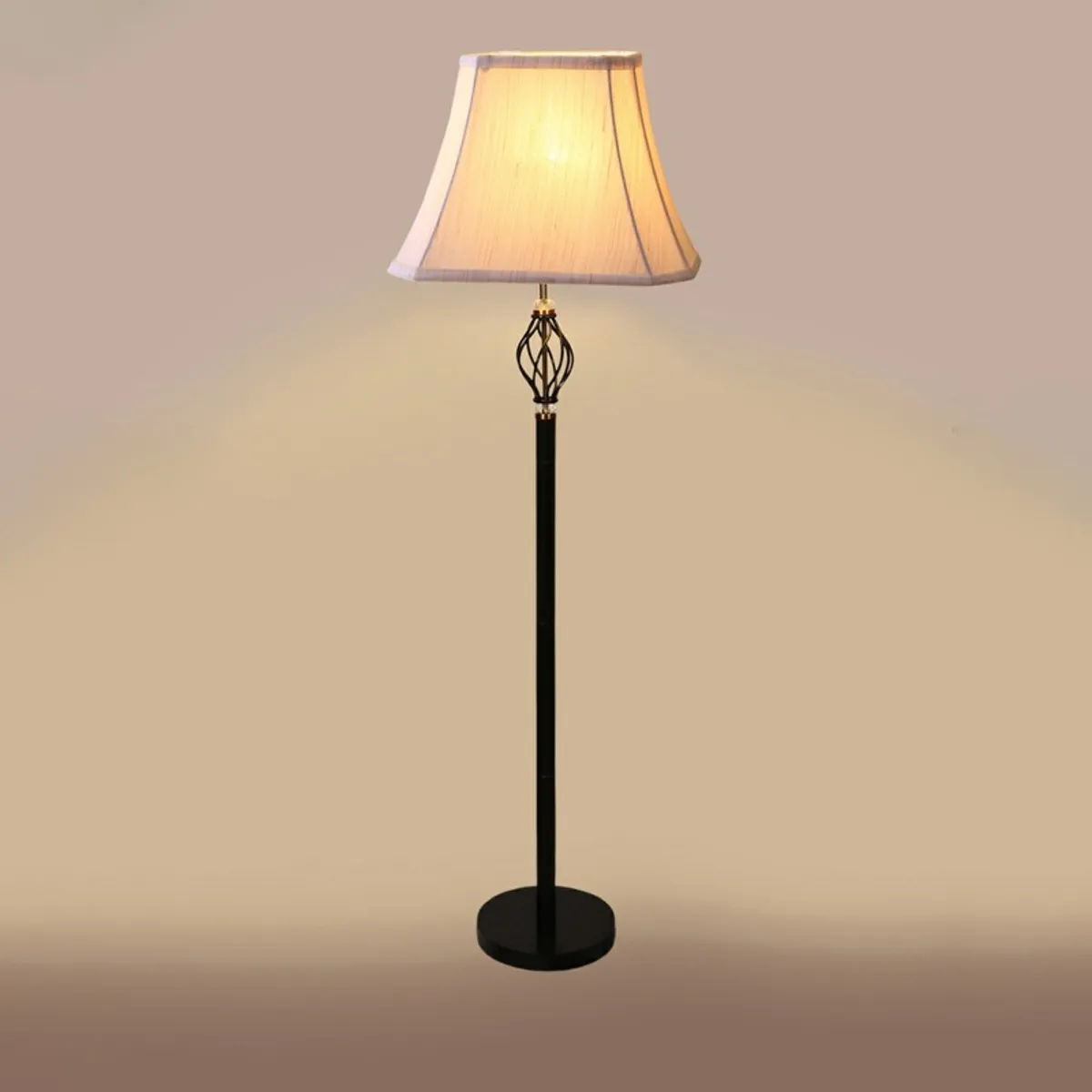 Floor lamp lit against a plain beige background