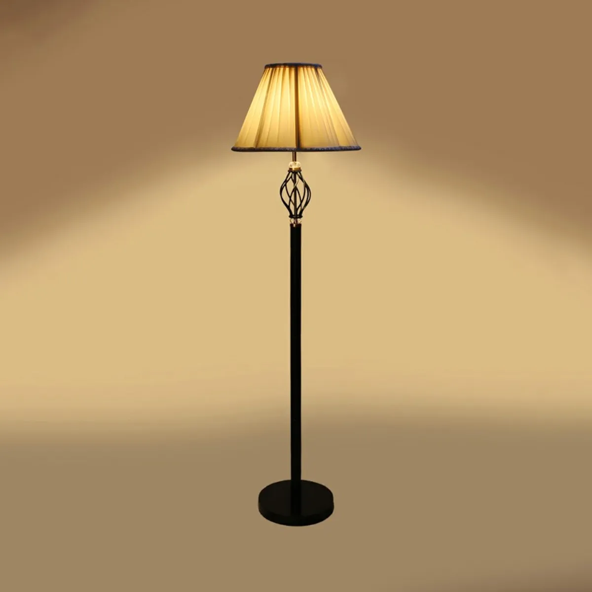 Floor lamp with warm glowing shade against a tan background