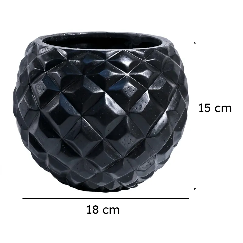 Black round planter with faceted geometric texture on a plain background