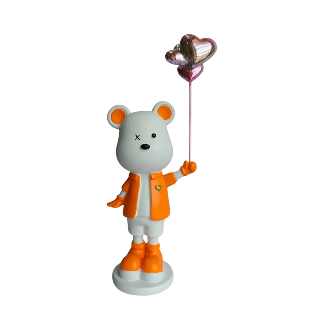 Front view of an orange and white bear figurine on a round base
