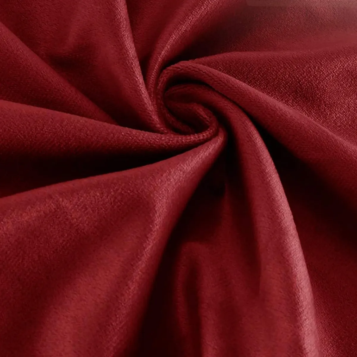 Close-up of soft maroon velvet fabric gathered into folds