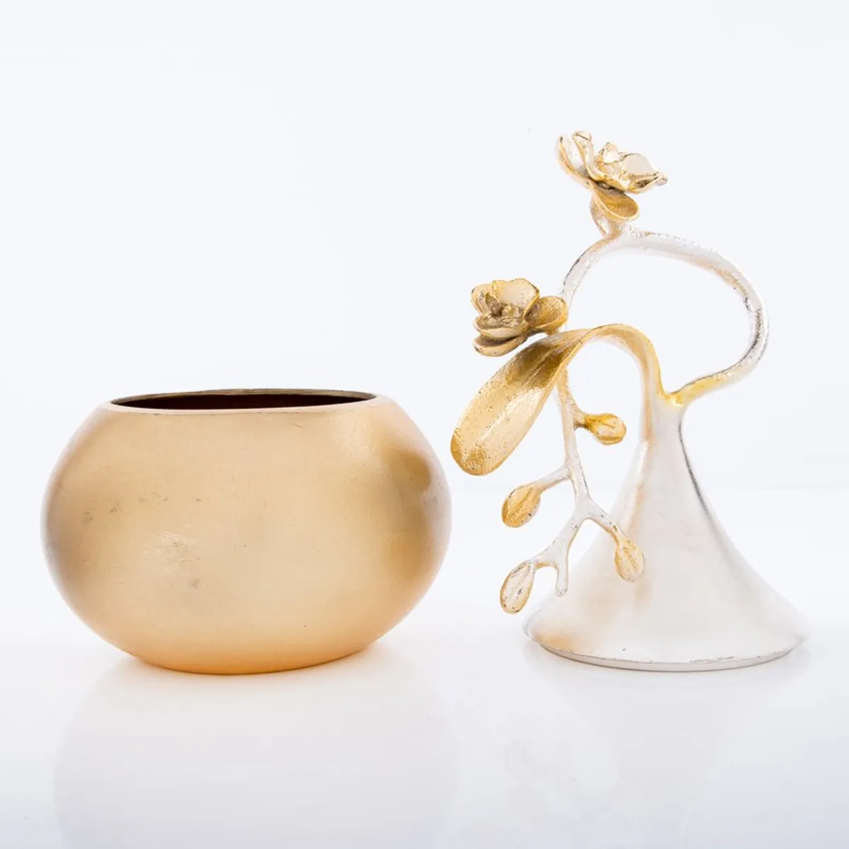 Open gold bowl beside its silver floral ornamental cover