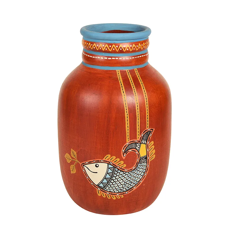 Front view of a red terracotta vase with blue rim and fish motif on a white background.