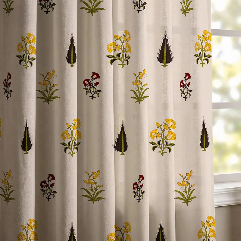 Close-up of off-white curtain with yellow and maroon floral print