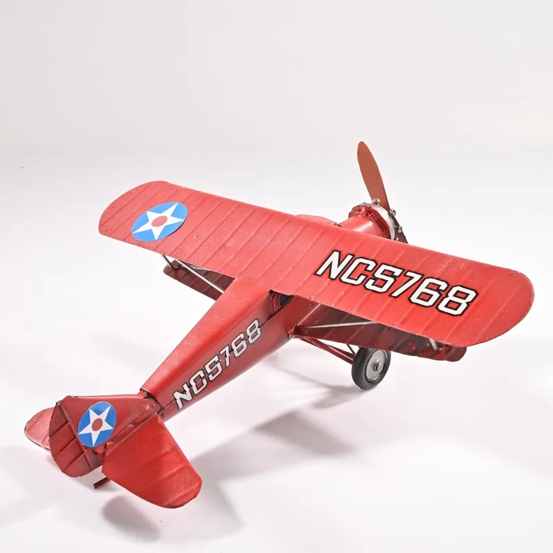 Rear angled view of the red aeroplane showpiece on a white background