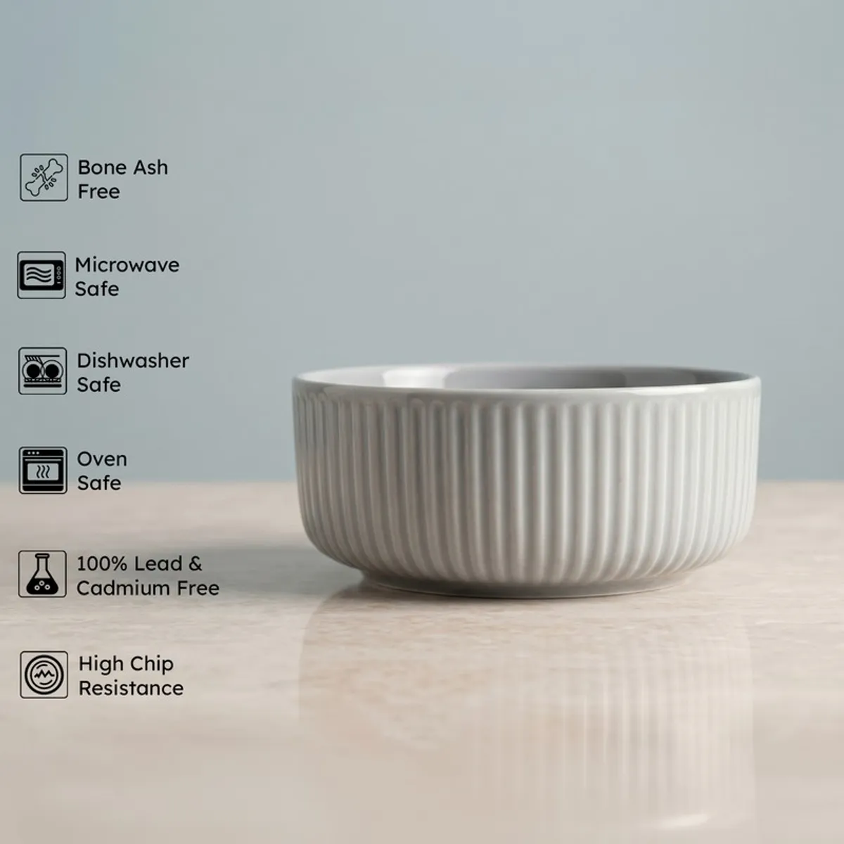 Grey ribbed serving bowl shown from the side on a tabletop