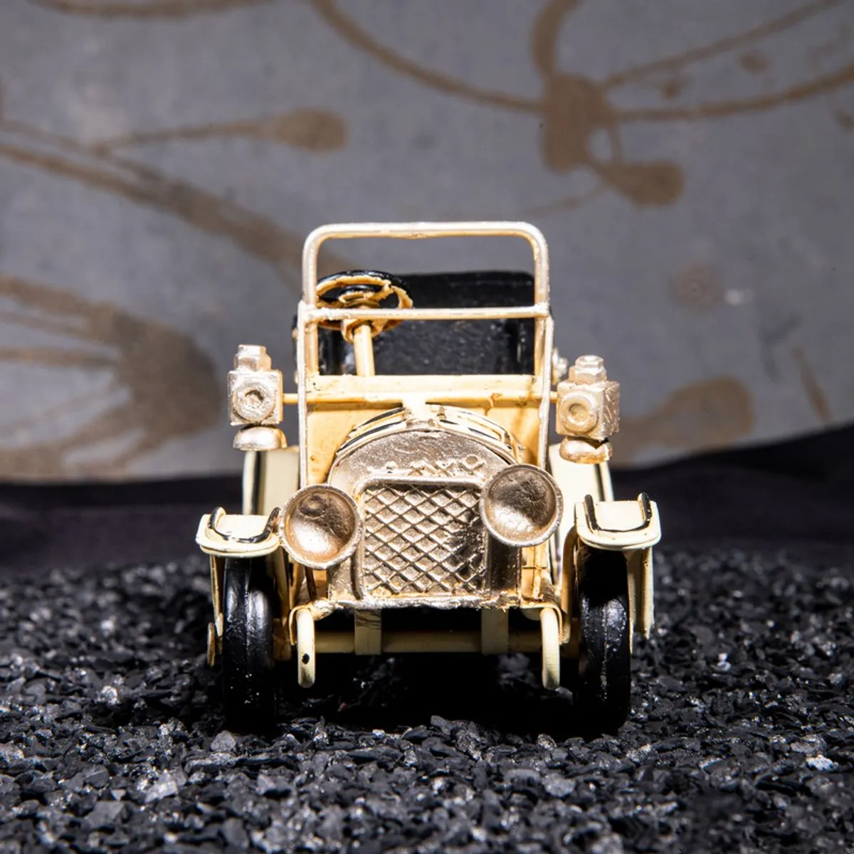 Front view of a vintage car showpiece with detailed grille and headlights