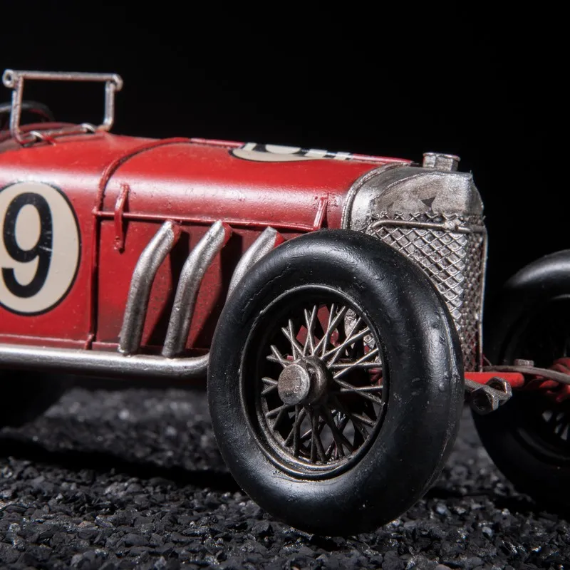 Close-up of the front wheel and grille of the red race car showpiece
